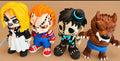 Four spooky figurines: a blonde figure, an orange-haired figure in overalls, a stitched figure with a top hat, and a brown werewolf.